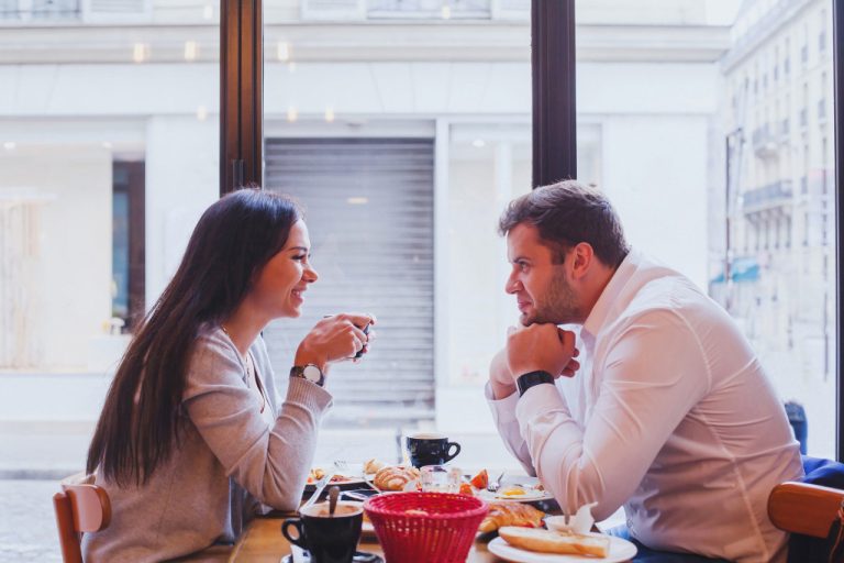 man woman eating in a restaurant having a conversation