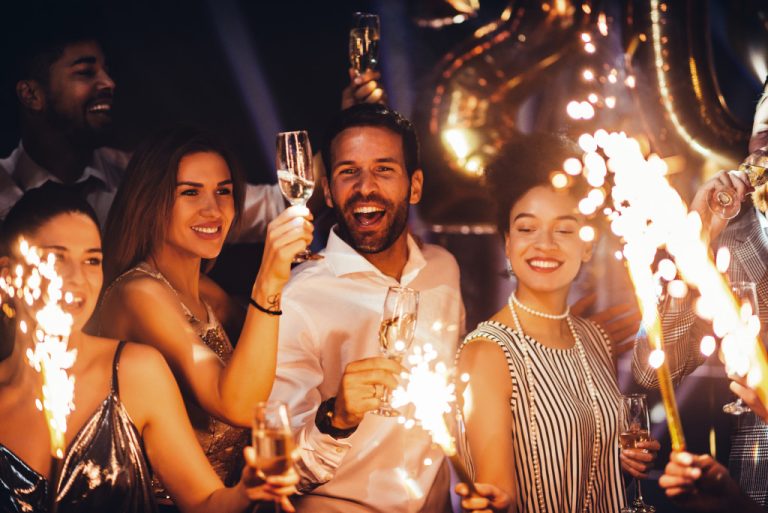 People having fun with champagne and sparklers at a party